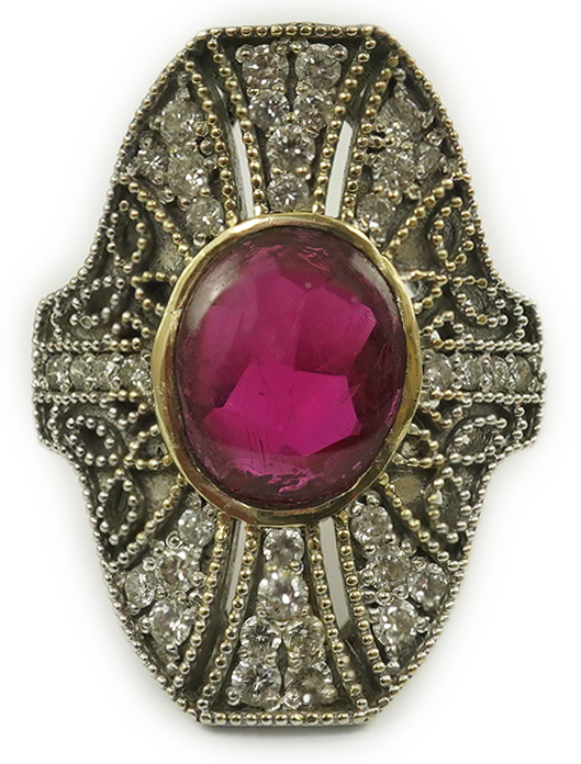 A gold, cabochon ruby and diamond cluster set upfinger ring